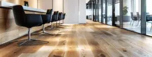a sleek, modern office space showcases a striking installation of floating timber flooring, highlighting the seamless design and rich texture under soft, diffused lighting.