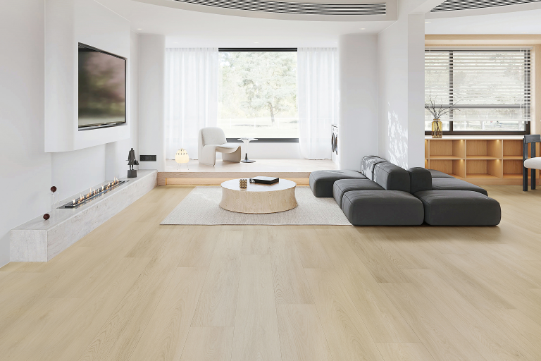 Modern living room showcasing light-colored vinyl flooring, stylish gray sectional sofa, round wooden coffee table, and contemporary decor elements, emphasizing eco-friendly and aesthetic appeal of vinyl flooring options.