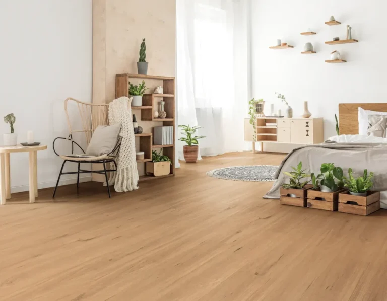Modern living room featuring hybrid flooring with realistic wood design, cozy seating area, decorative plants, and stylish furniture.