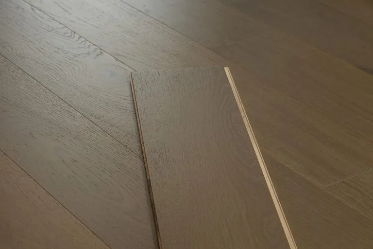 Royal 14/2mm Oak flooring plank in Mocha color, showcasing wood grain texture and precision craftsmanship on a hardwood surface.
