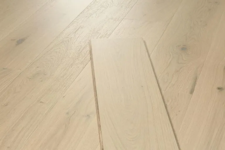 Royal 15/4mm Oak flooring in Linen color, showcasing a hand-graded French Oak veneer with visible wood grain texture and natural light reflections.