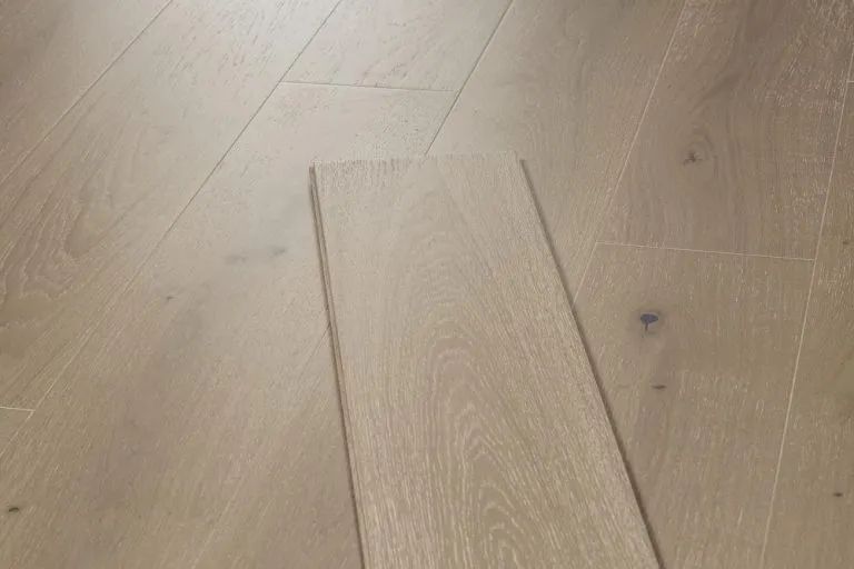 Limed Grey 15/4mm Oak flooring plank showcasing a natural wood grain finish, highlighting the elegant texture and color suitable for stylish home interiors.