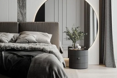 Bamboo flooring in a modern residential bedroom, featuring a stylish bed with gray bedding, a round mirror, and decorative elements.