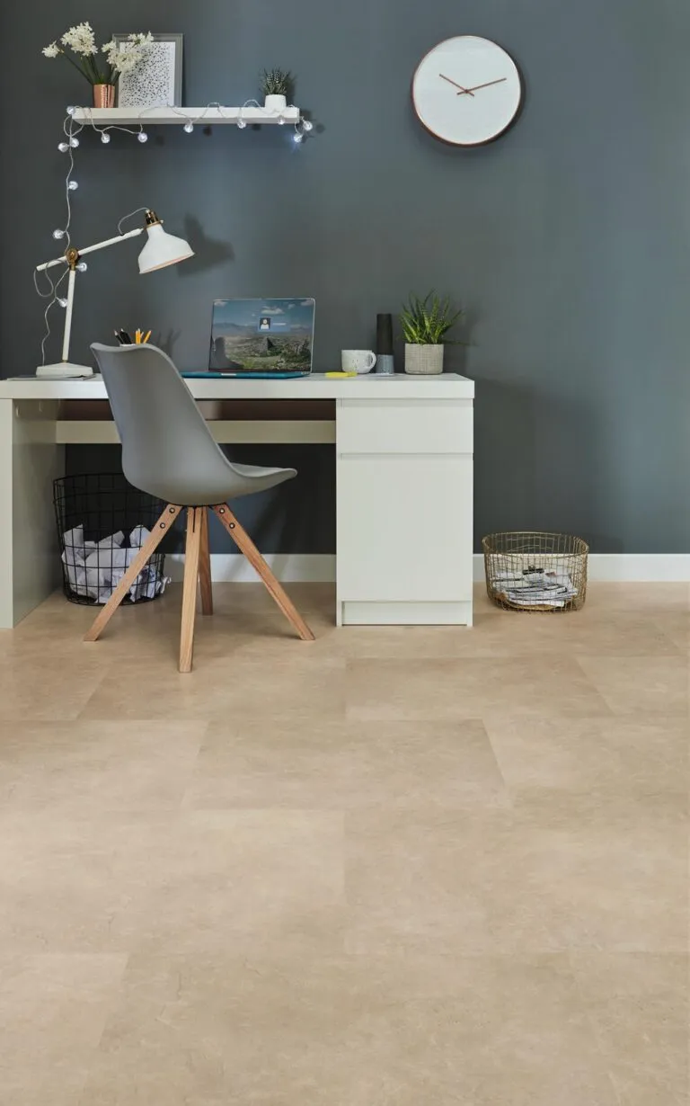 Modern workspace featuring Maine color Loose Lay Originals luxury vinyl flooring, desk with laptop and decorative plants, against a dark wall.