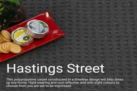 Hastings Street Ash Grey designer loop pile carpet with textured weave, showcasing cheese and crackers on a red plate, emphasizing luxury and durability for modern Australian homes.